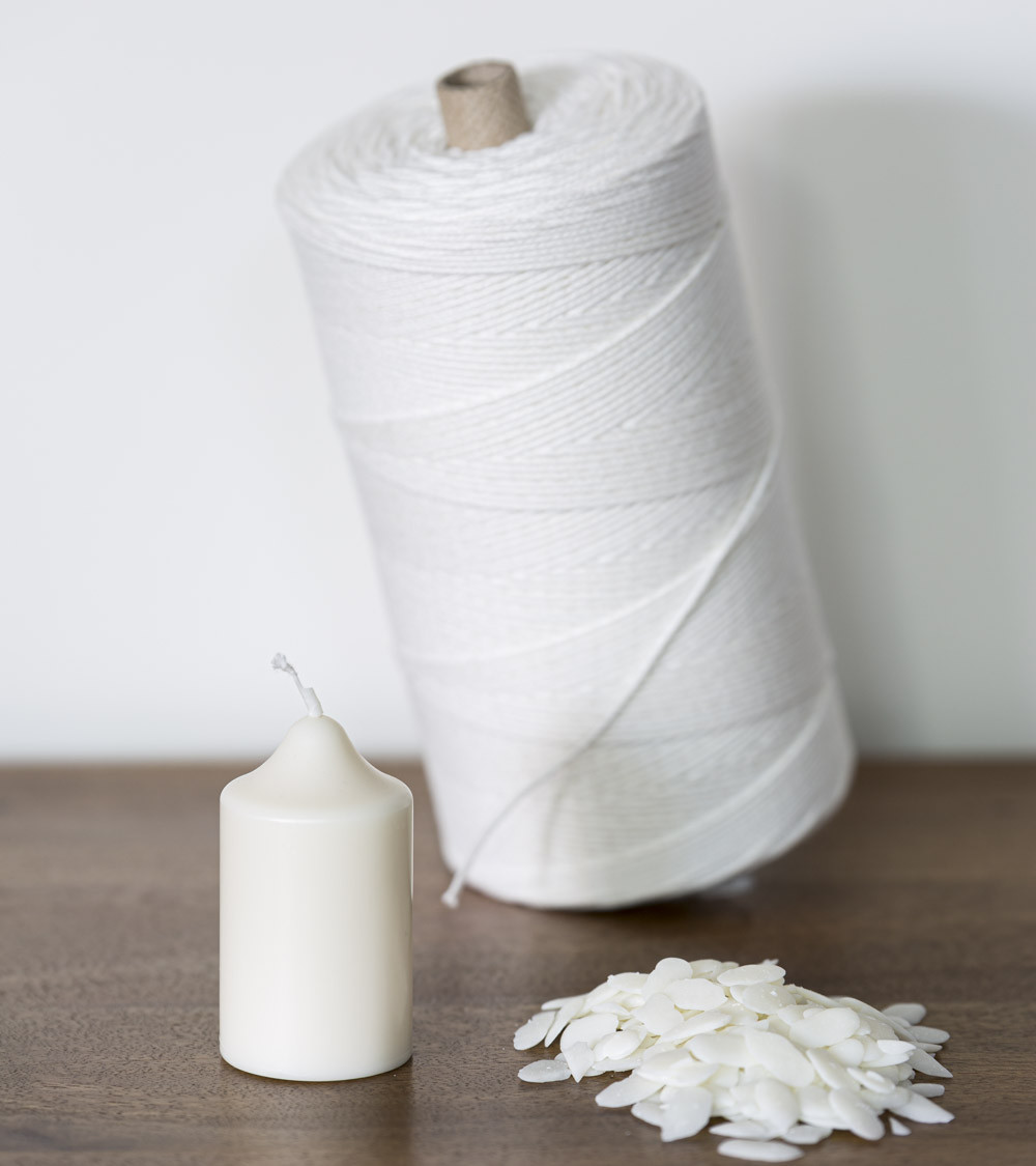 Bougie naturelle en cire de colza avec rouleau de mèche et paillettes de cire sur table en bois